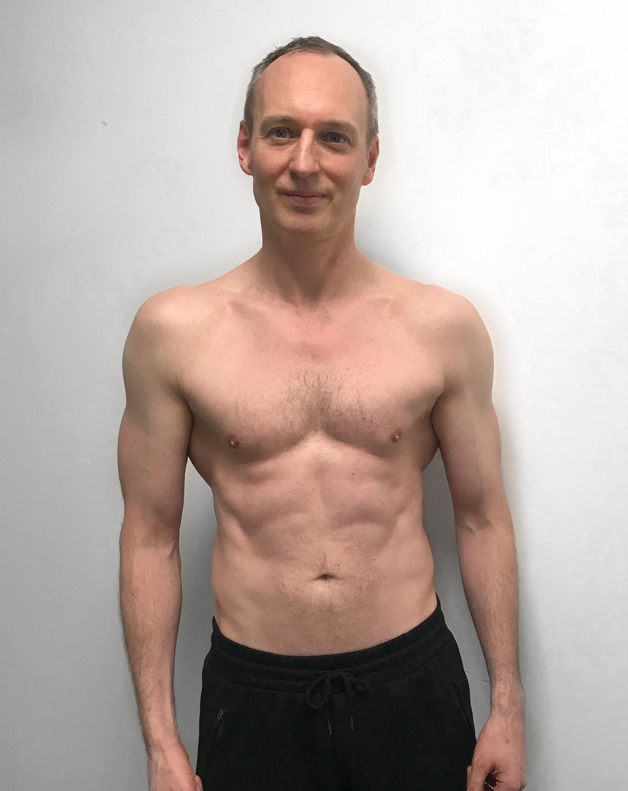 Male body transformation after photo showing muscle building at Roar Fitness