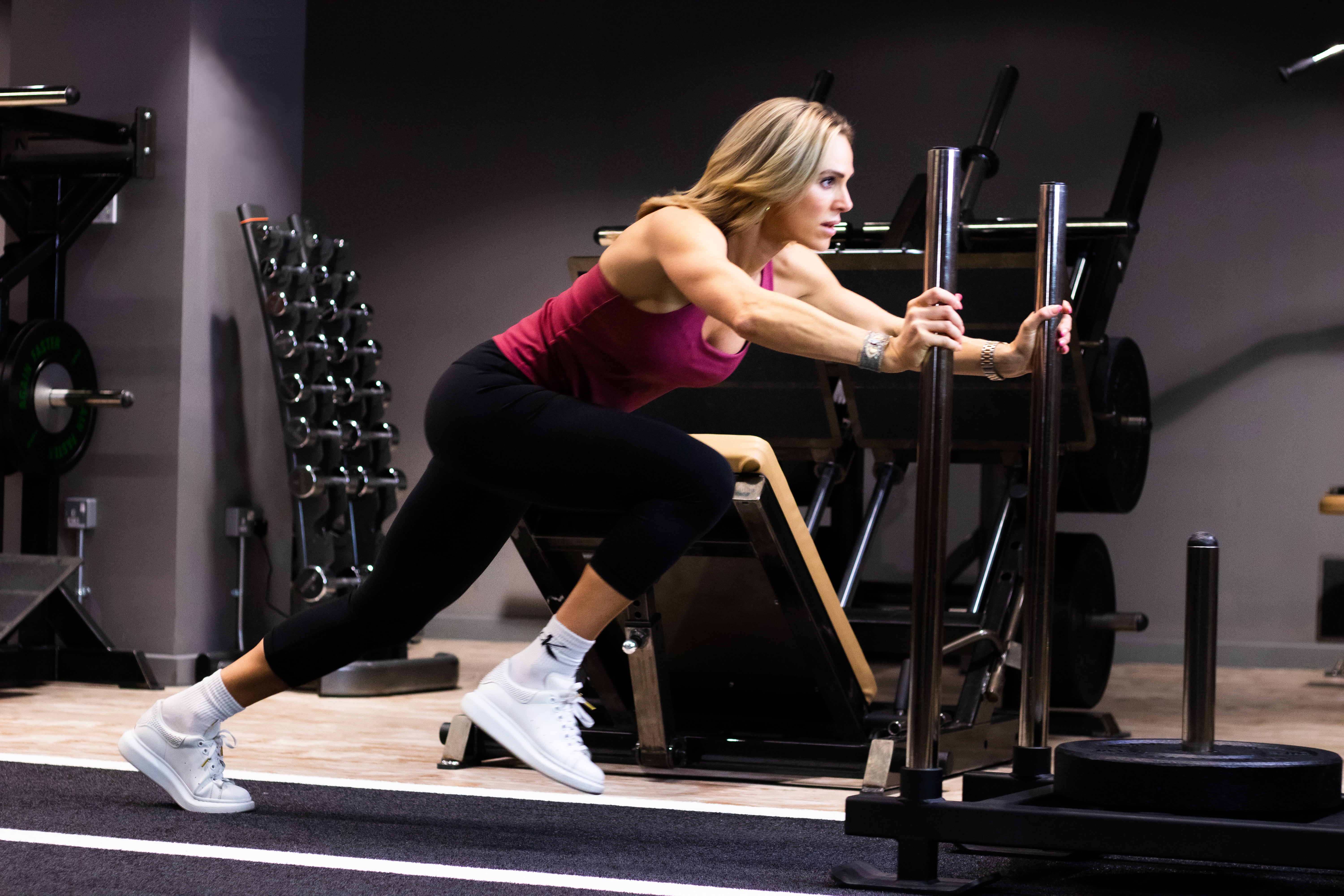 A sled push exercise in a gym, highlighting strength and conditioning training with Roar Fitness.