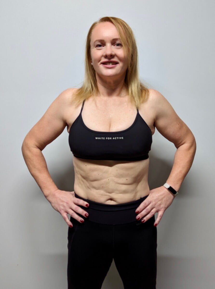 Female client showing body transformation and fat loss results from personal training at Roar Fitness London