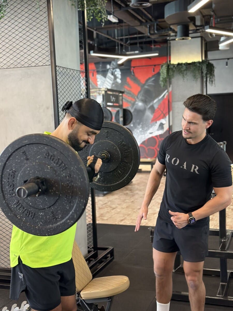 Personal trainer coaching strength training at Roar Fitness Dubai gym