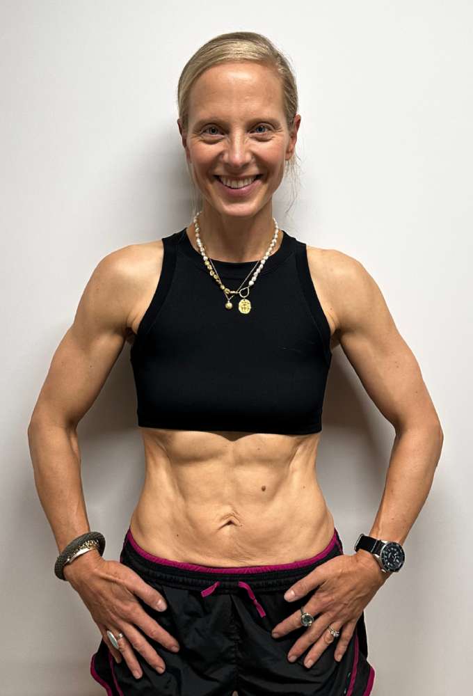 Lucy's after photo showing lean physique and visible abs from body transformation at Roar Fitness London