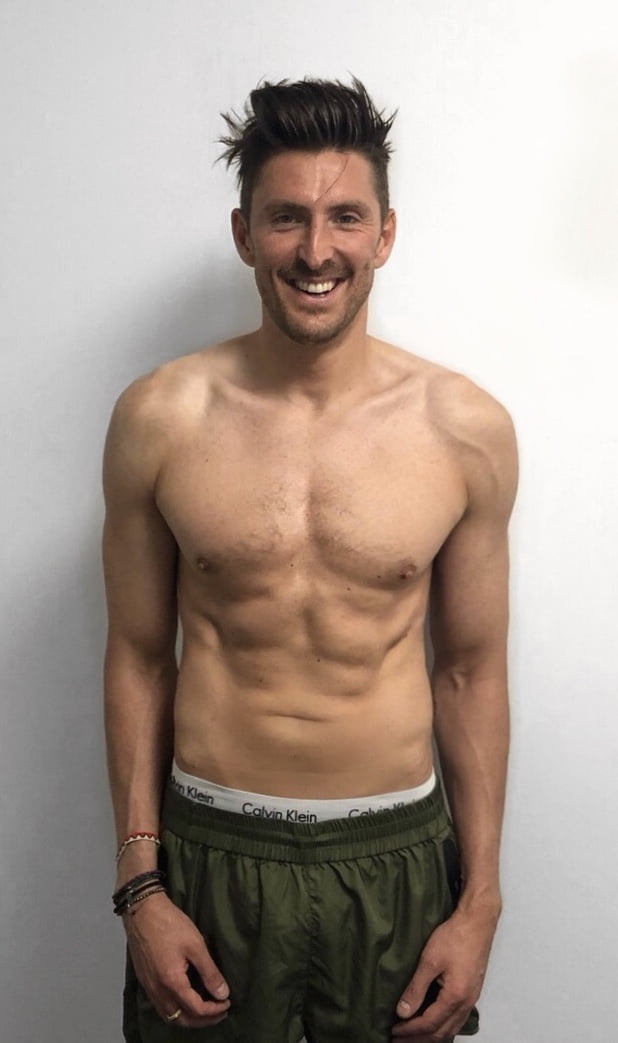 Henry Holland smiling, shirtless, after his training programme at ROAR Fitness