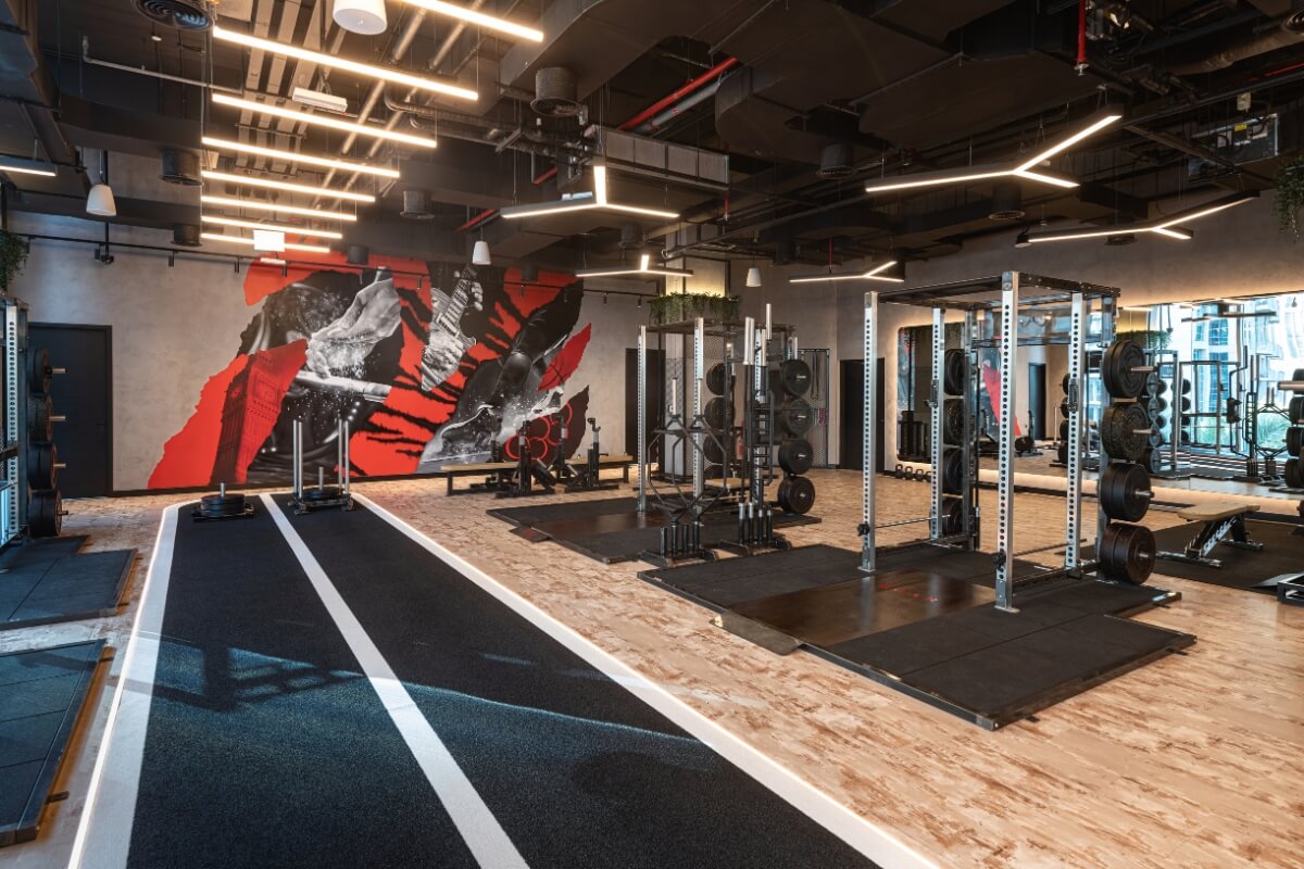 Personal training gym floor at Roar Fitness Dubai with squat racks and sled track