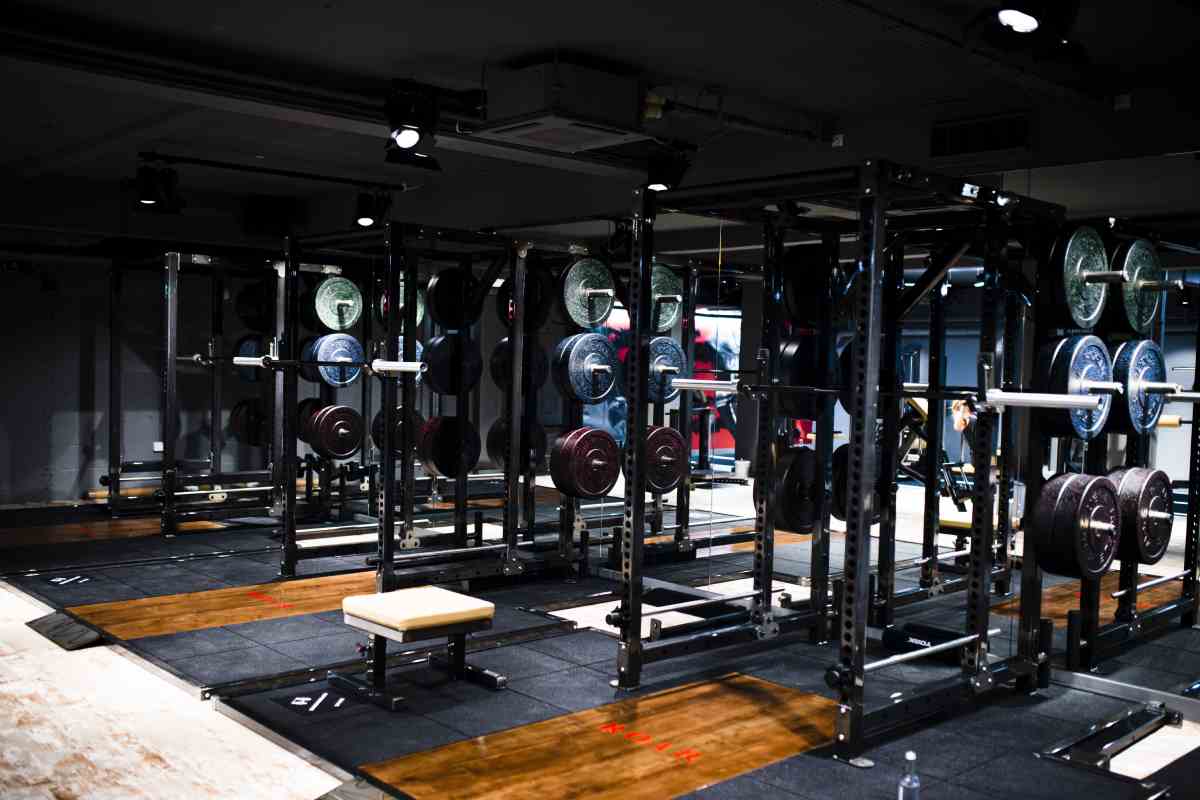 Strength training area at ROAR Fitness Kensington with power racks, Olympic barbells and wooden lifting platforms